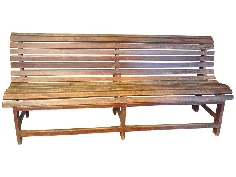 A terrific slatted bench in painted wood originating from a train station in Portugal. A wonderful piece for a long gallery hallway, porch or loggia.