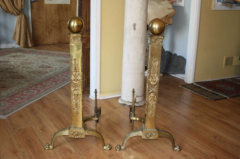 French antique Empire style bronze and brass andirons with claw feet. These andirons have a great scale and are perfect for homes with very large fireplaces. These andirons are sure to bring a touch of elegance to any room that they grace.