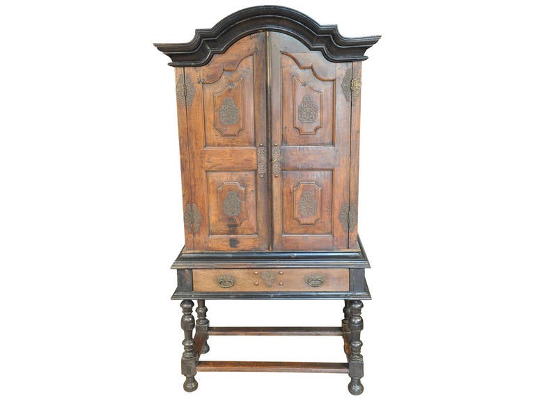 A very handsome 18th century Portuguese Deux Corp Cabinet in walnut.  This striking cabinet is a fine example of Baroque styling....  Beautifully molded cornice over shaped and molded door panels adorned with metal work.  The cabinet rests on the