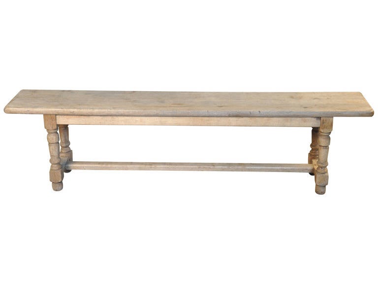 A charming French 19th century bench in washed oak, circa 1880.  This bench will serve nicely at the foot of a bed, along side a farm table or under a picture window.