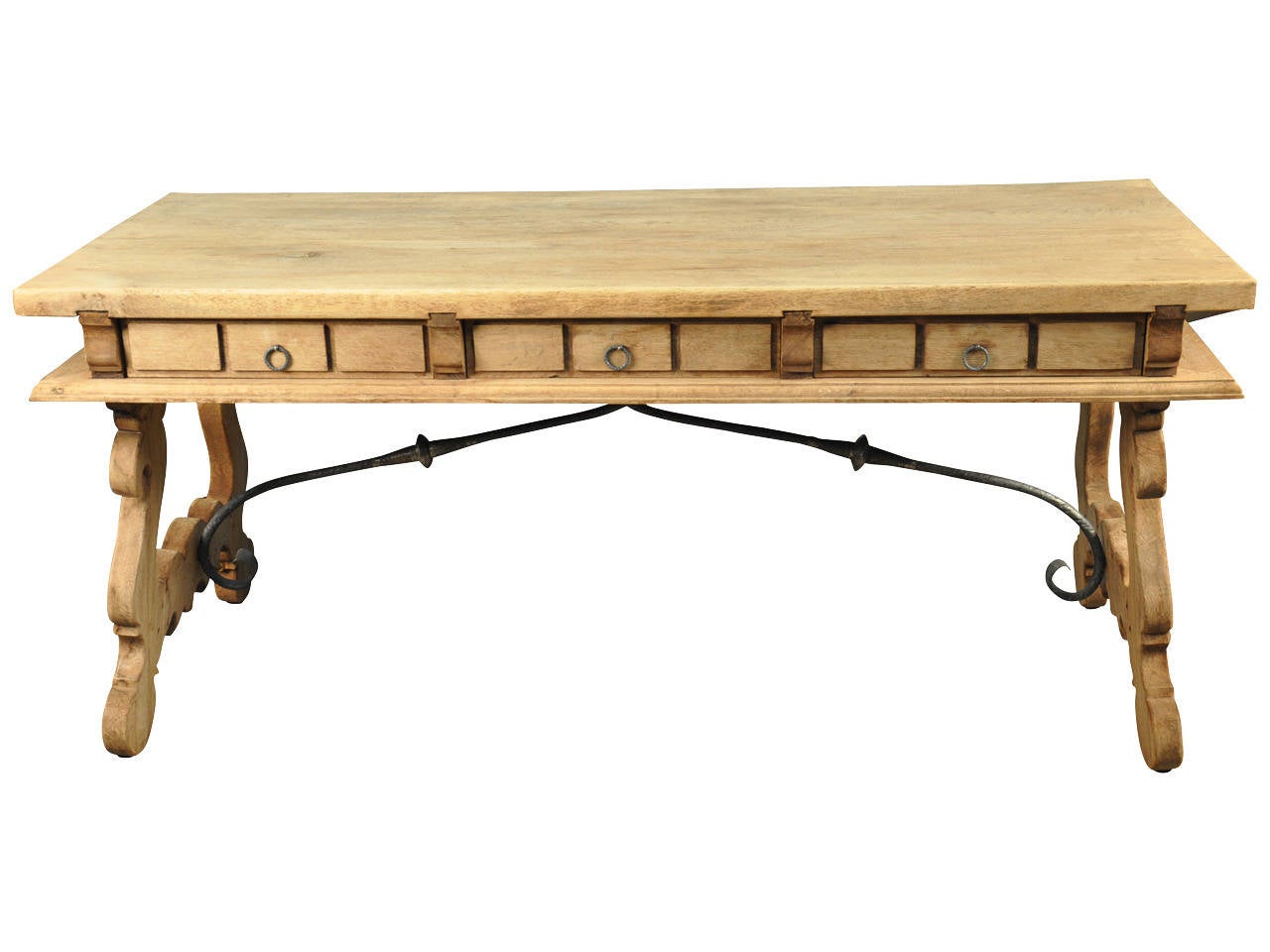 A very handsome desk or writing table in washed oak from the Catalan region of Spain.  This piece has three drawers, beautifully sculpted legs and iron trestles.  Not only does it serves as a wonderful desk, but as a sofa table or console as well.