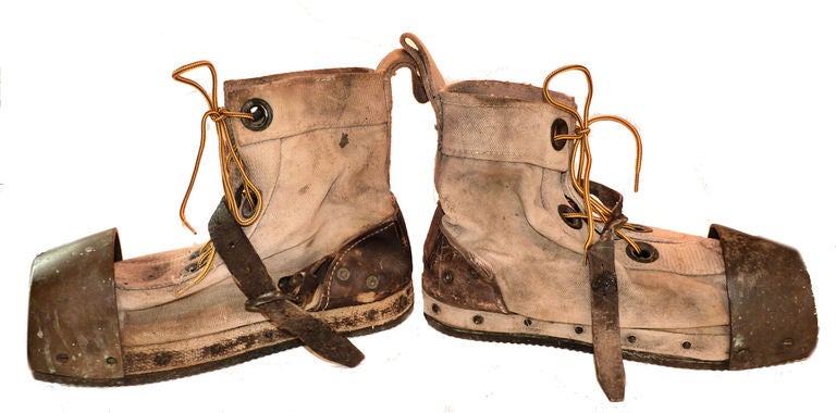Presented are a well used pair of authentic American design mid-century hard hat diver's boots.  These hefty diving boots are made from heavy canvas tops which are mounted to  a wood sole by a series of 13 brass screws for each boot. The sole in