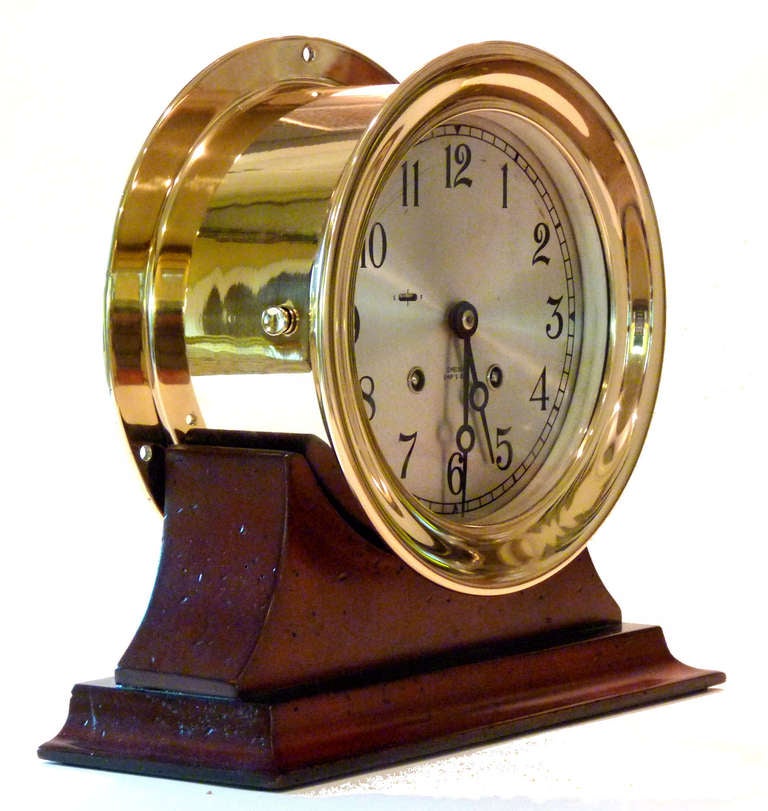 STAND INCLUDED A $75.00  VALUE

A full 6 inch size ship's bell clock which strikes the hour and half 
hour in a lacquered brass case. Immaculate, near new condition.

Presented is an outstanding example of the finest striking bell clock made.