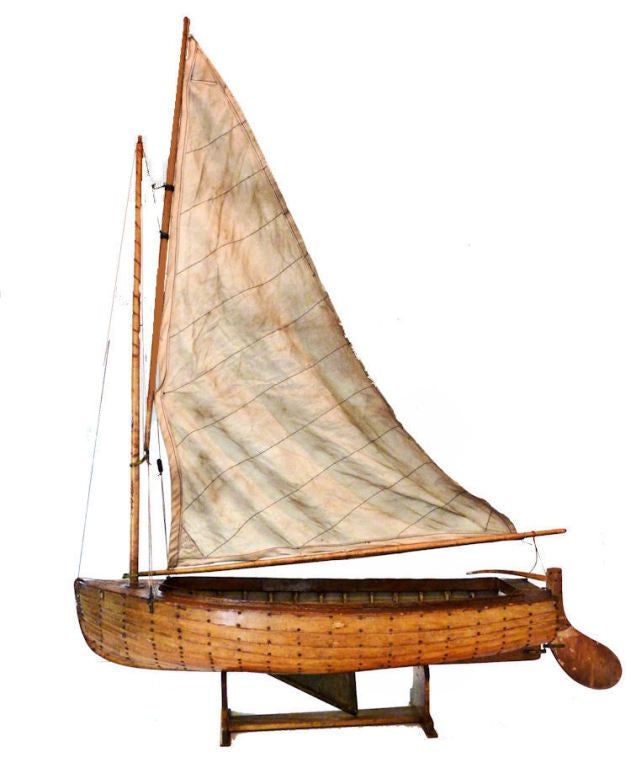 It has a lead centerboard which means it might have been used as a Pond Yacht. On its stand, this handsome relic displays as a fine work of American Nautical Folk Art.

The design dates back to the 1870's, and with minor modifications, was popular