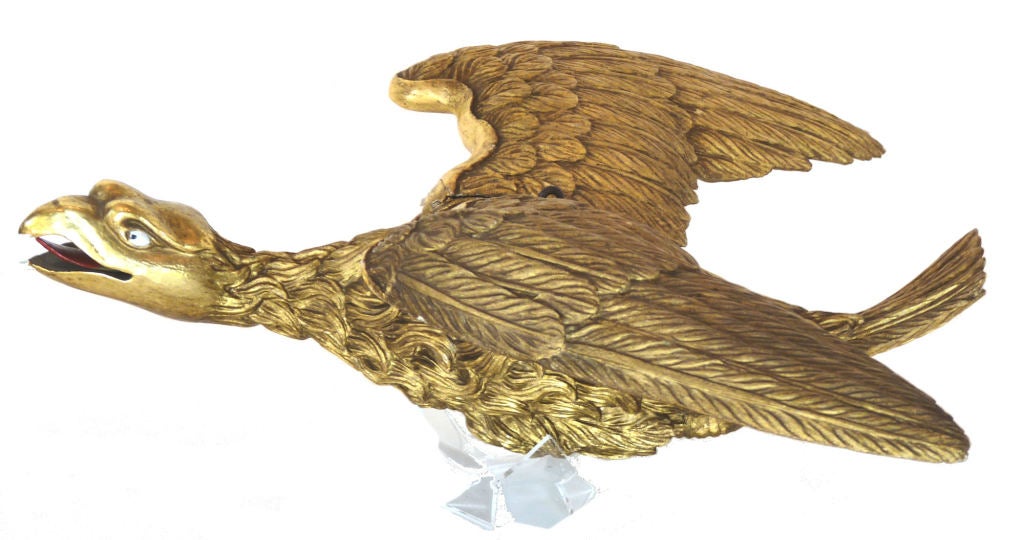 This fine carving of a gilded Flying Eagle circa 19th Century is unique in this form.

Presented is a rarely seen form of a stylized antique gilded carved wood eagle in flight. The 19th Century workmanship is done with precision with the