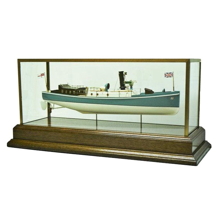 Presented is a magnificent cased builder's model of the early 50 foot steam launch which was designed for use by a capital ship to move personnel from shore to the warships, as a guard ship, and later as a harbor patrol craft. In the configuration