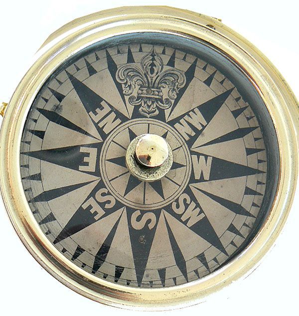 Shown is a truly fine dry card tell tale compass. It has a paper card which has the directions printed on it so when it is mounted overhead, as it would be on a vessel, are seen correctly. This allows for viewing them properly oriented when seen