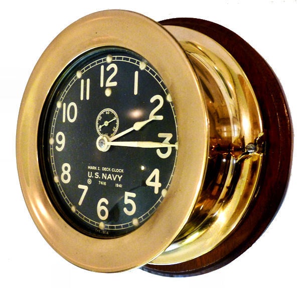 This is a rare finely made Chelsea, back winding, Navy Deck clock with a hinged bezel that is different and more refined than the numerous examples housed in nickel cases that were made by Seth Thomas. This clock's case is bronze which has the