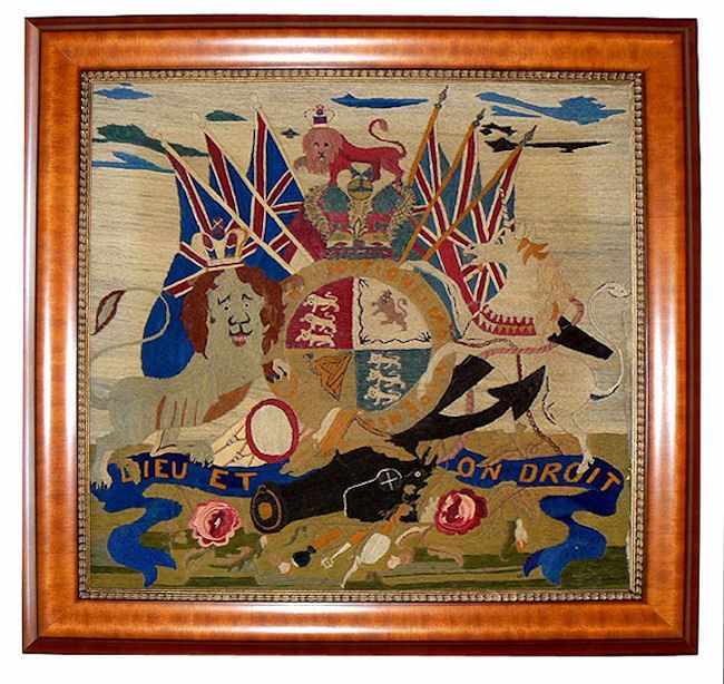 PRESENTED is a beautifully executed woolwork, which frequently is referred to as a woolly. It is marine Folk Art and portrays the Royal coat of arms of the United Kingdom in a handsome period style frame. The cannon, drum and anchor beneath the
