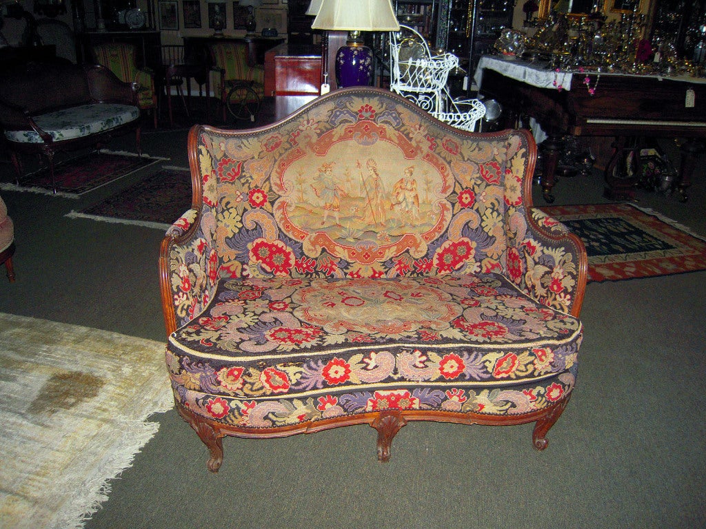 Napoleon III/ Louis XV style vibrant French loveseat with original needle-pointed upholstery and petit point inset