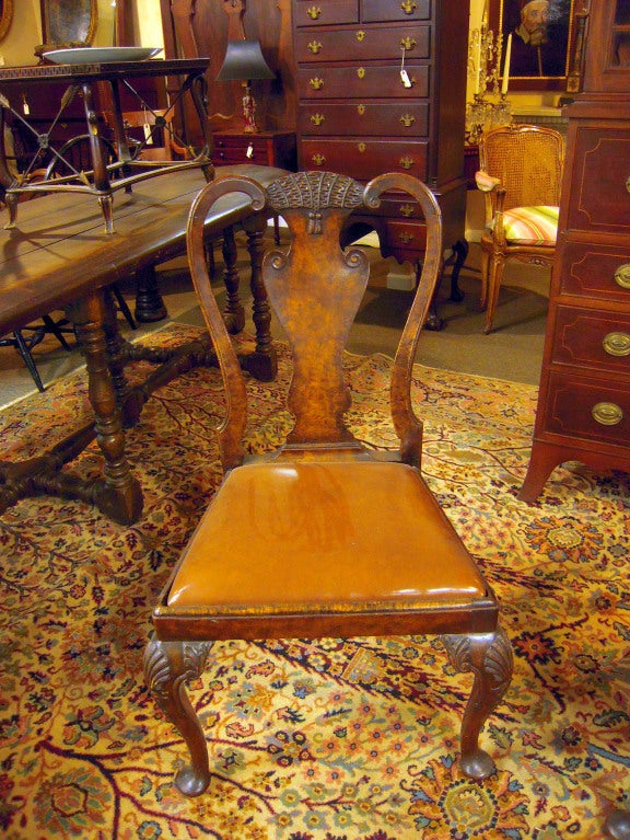 Set of 8 Queen Anne style burl walnut dining chairs, 2 arms and 6 sides. Hand-carved  tassel decorated back with whimsical eagle?s head arms. These are a farm-fresh find, and will be professionally restored prior to shipping to ensure sturdiness and