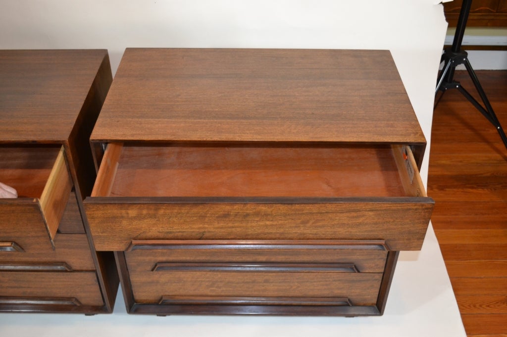 Pair of beautifully restored gentlemen's chests/dressers by Milo Baughman for "Perspectives" series by Drexel. Fabulous two-tone mahogany wood, these four-drawer chests sparkle in the sunlight.