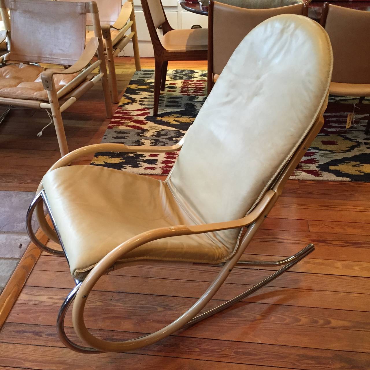 Classic 1970s Paul Tuttle Nonna rocking chair. Frame of chrome-plated tubular steel and bent beech wood. Upholstery of cream leather over strap support of natural canvas.