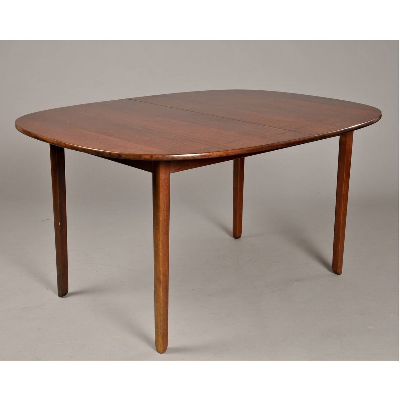 This elegant and functional Ole Wanscher dining table is from the well-known “Rungstedlund” collection. The table includes two extension plates and can seat up to ten people comfortably.

Length without extension plates - 57 inches.
Length with