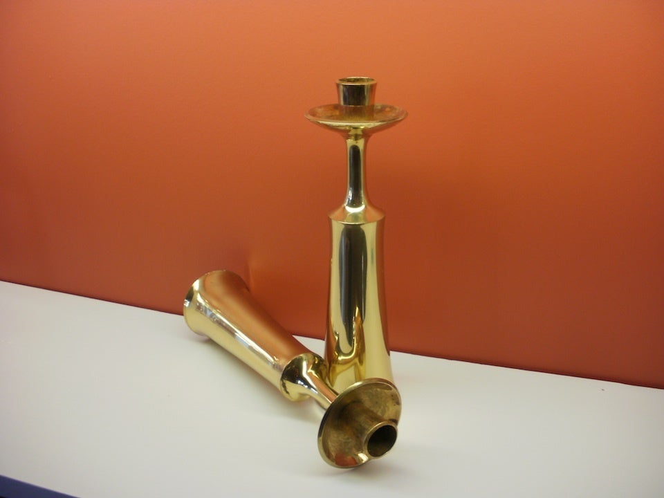 A pair of elegant brass candle holders by Danish designer Jens H. Quistgaard.