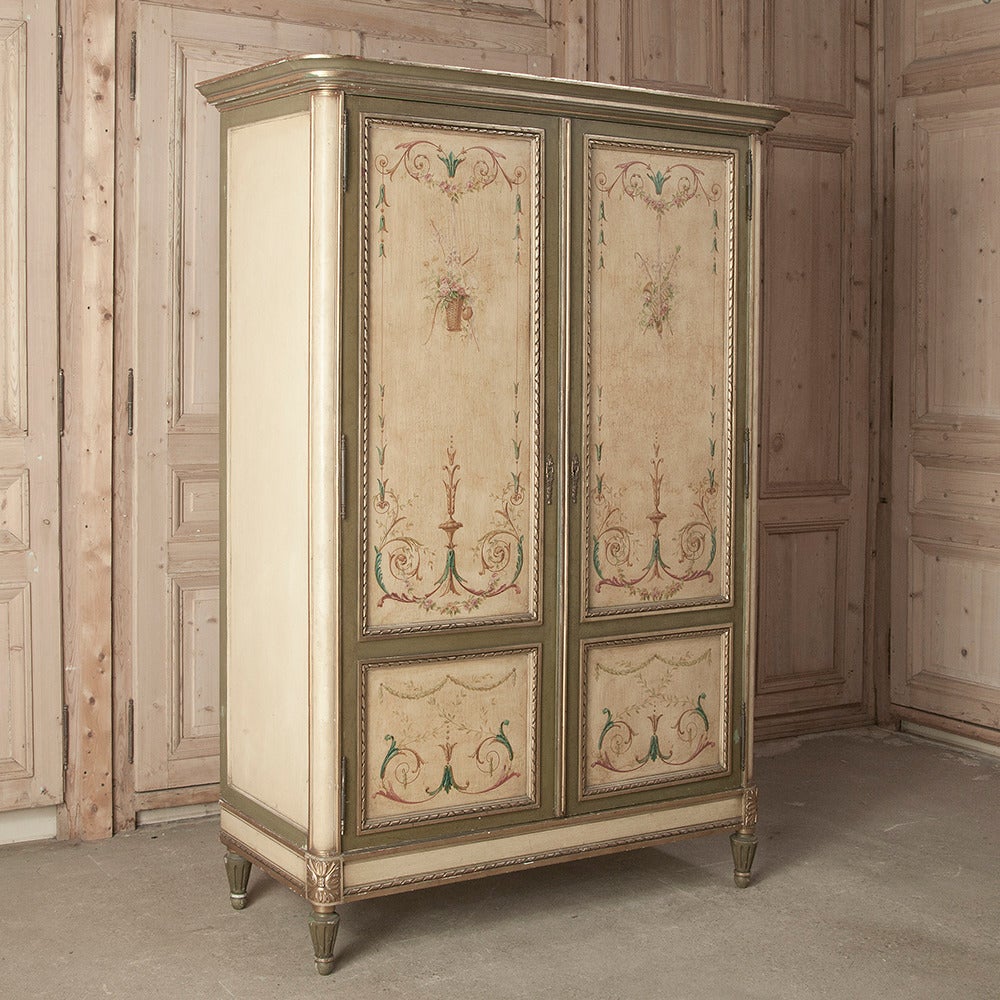 This stunning French Louis XVI style armoire hand-crafted from walnut and mahogany by David Freres of Marseille boasts its original rare hand-painted adornment all across the entire facade, and on every member of its construction. Intricate molded