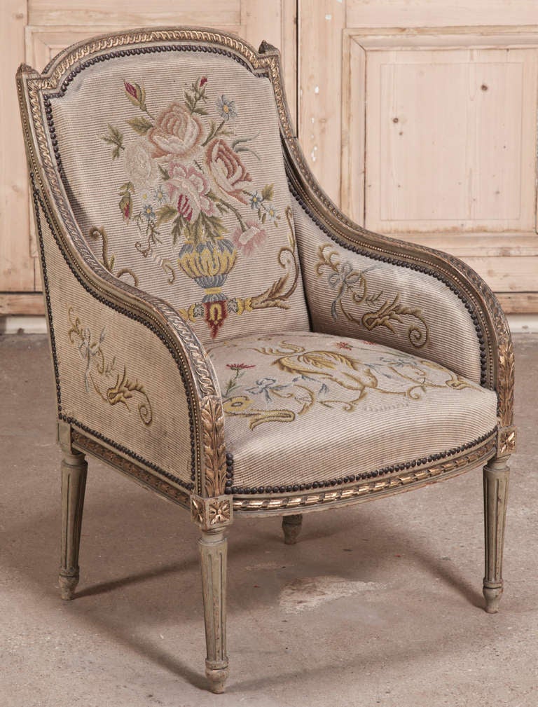 This pair of antique French needlepoint tapestry bergeres are a part of the salon set which is sold separately (see the other related items by clicking on the thumbnails below) would be icing on the cake for any seating group, showing finely carved