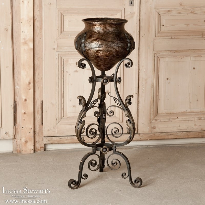 This elegant hand-hammered antique copper Jardiniere is styled after ancient Greek Amphora, and comes with its original hand-wrought iron Stand with elaborate foliate and scrollwork detailing. Perfect for displaying fresh greenery and/or flowers,