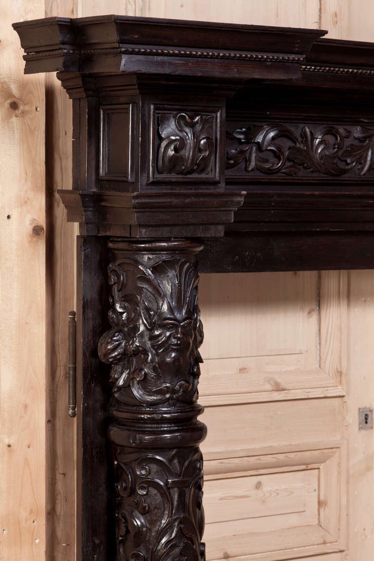Exquisitely hand-carved in the elegant Italian Baroque manner then given a dark stain for a timeless look, this Antique Italian Baroque Fireplace Mantel Surround clearly displays the talents of the Italian sculptors who lovingly fashioned the wood