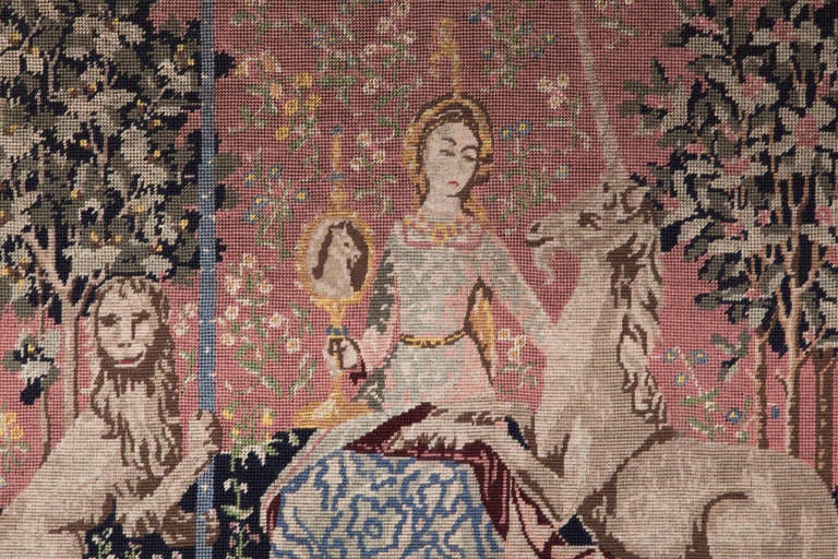 This lovely Antique Framed Needlepoint Tapestry is a recreation, the original entitled The Lady and the Unicorn (French: La Dame à la licorne), which is the modern title given to a series of six tapestries woven in Flanders of wool and silk, from