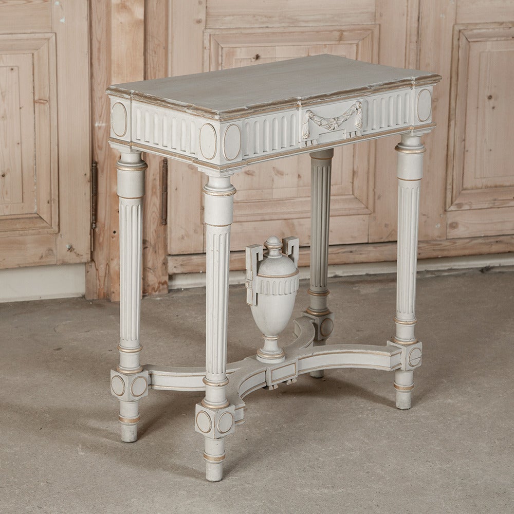 Perfect for a diminutive space, this antique French Louis XVI style painted console adds a classical touch with a light and airy presence.  The original paint has achieved a lovely patina over the past century!
circa 1900-1910.
Measures: 31 H x 27