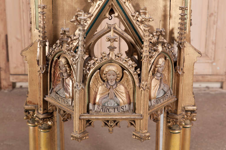 Hand-carved to an impeccable degree of detail, this amazing Antique French Gothic Carved Wood Shrine stands over six and a half feet tall and boasts a wonderful patina thanks to its original painted finish and gold highlights! 
Circa 1850s.