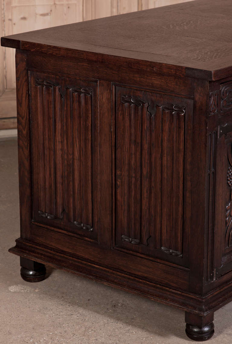 Hand-crafted from solid European red oak, this handsome desk features linenfold panels melded with finely carved panels and drawer tier for a definitive Old World touch. Spacious storage swallows up all your office accoutrements. 
As of this