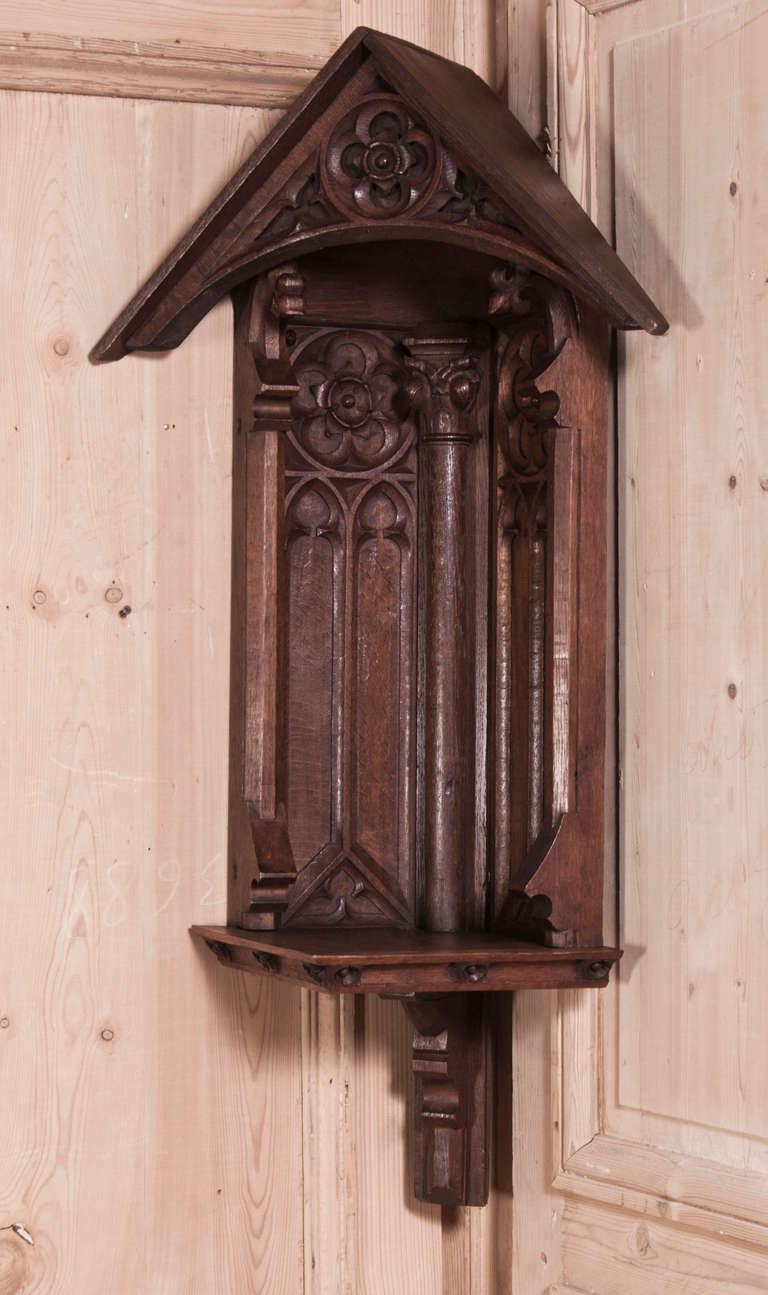 Designed to hold a religious statue and be mounted in the corner, this beautifully crafted Antique French Gothic Corner Shrine was sculpted from solid French oak to last for centuries! 
Circa 1850s. 
Measures 43H x 21.5W x 16D; 12 corner to edge