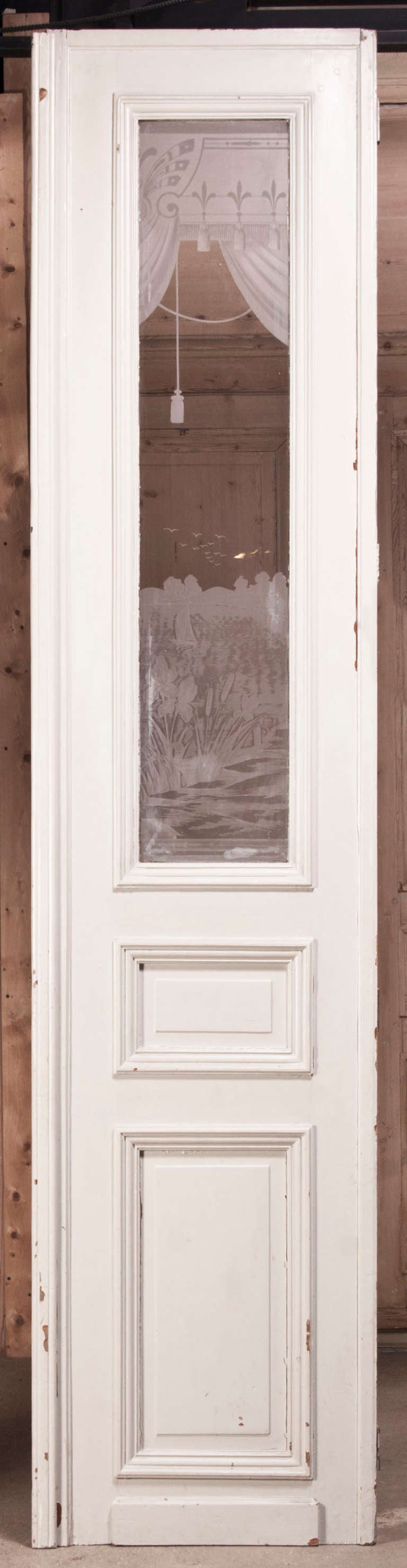 This remarkable set of four antique doors with etched glass cleverly depict a view through a window of a lush landscape framed by curtains, all etched directly into the glass to create a permanent record of the talents of the artist who created it!