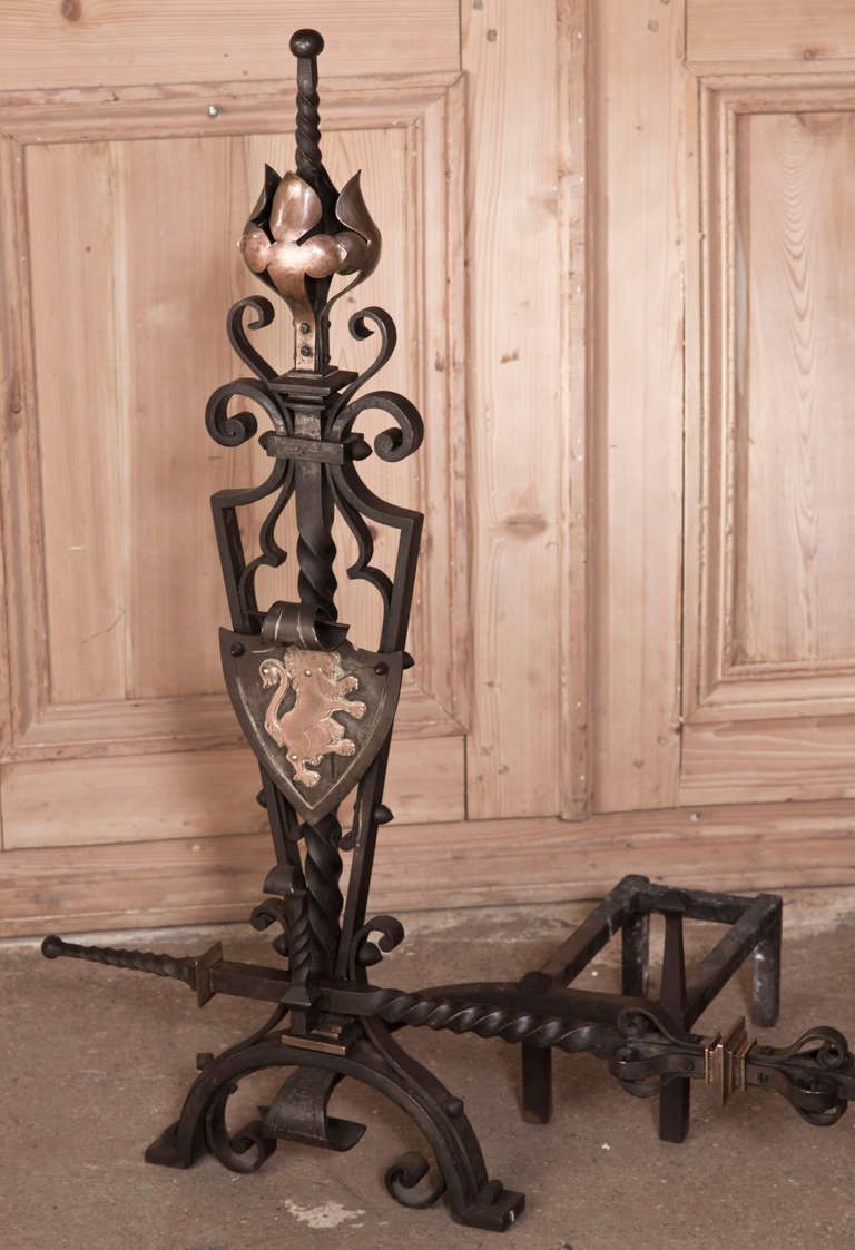 Elaborately forged from red-hot iron, this pair of andirons will really dress up your fireplace hearth. 
Circa 1870s. 
Each measures 37H x 16W x 20D