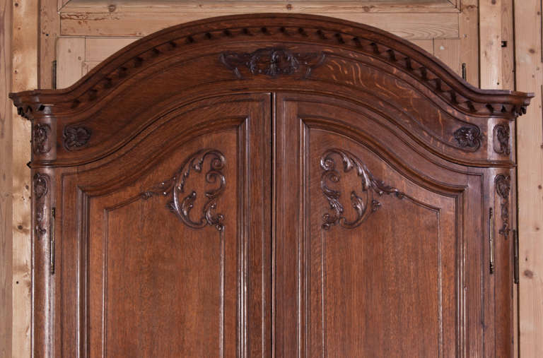 This exquisite example of French craftsmanship is a wonder to behold!  An Antique Country French Armoire such as this splendid example would have been considered a family's finest and most cherished piece of furniture.  A particularly finely-crafted