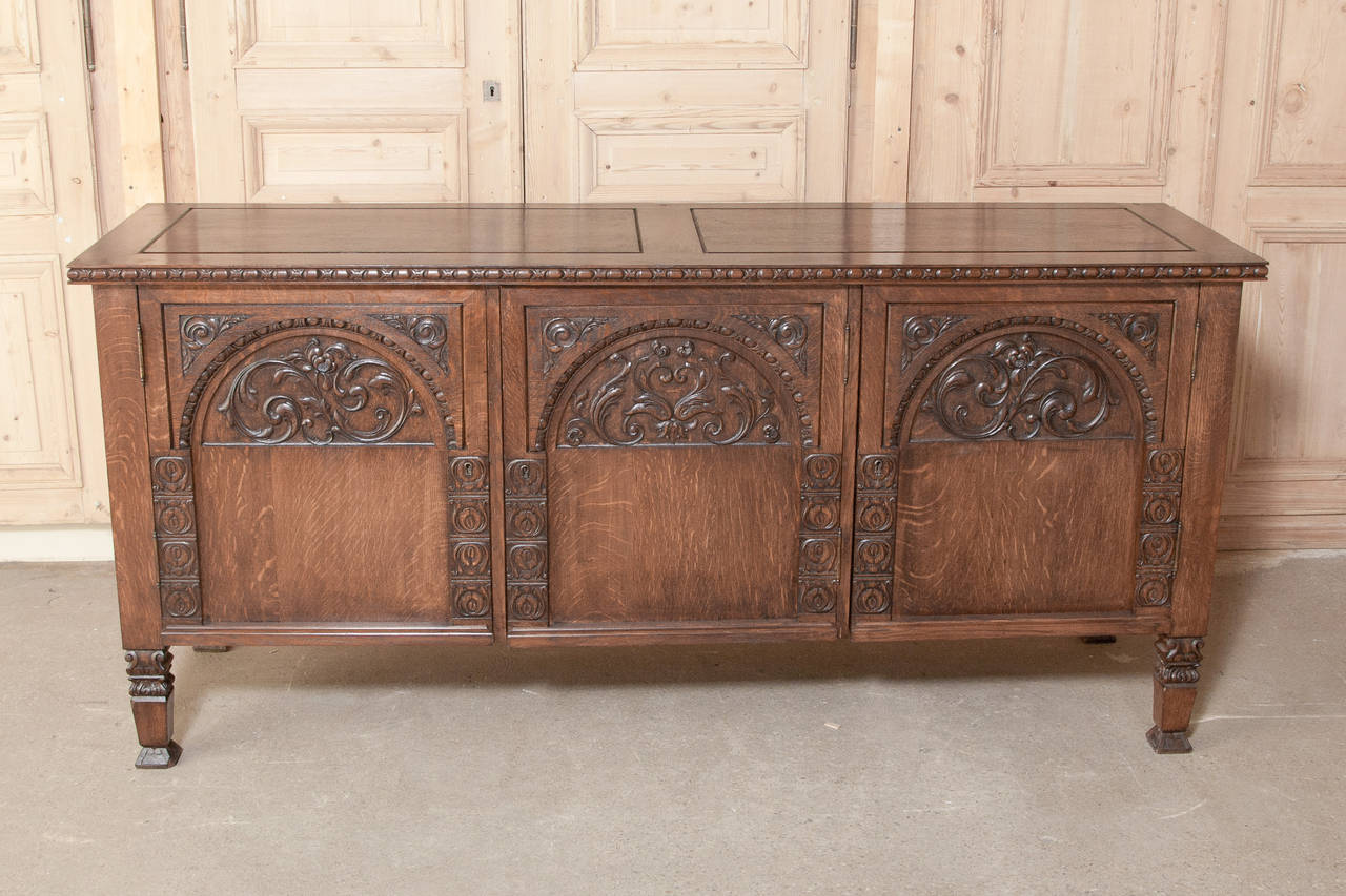 Crafted exclusively from white European oak, this buffet features intriguing Gothic arch motifs with fine hand-carved detailing. 
circa early 1900s. 
Measures: 37 x 79 x 23.5.