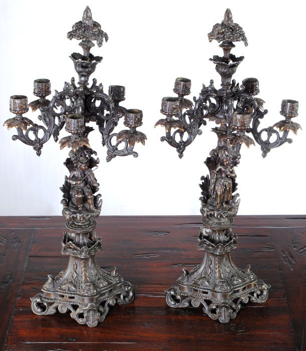 The charming and unique visages of a fair maiden and young lad have been cast into the design of this pair of French candelabra, giving them a charming Renaissance Revival 19th century whimsy that is at the same time an elegant accent for your