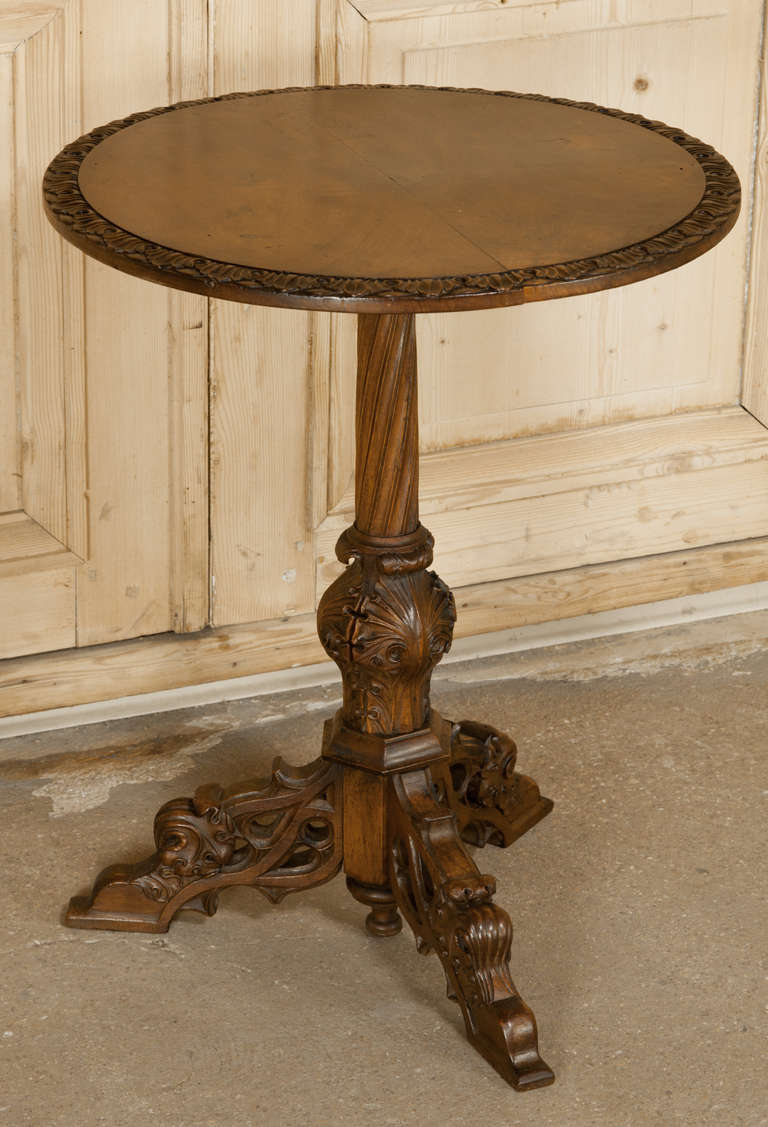 Perfect for any seating group, this Antique Gothic Walnut End Table reflects a more subtle interpretation of the style, with elegant carved tripod base and pedestal supporting the round top.  The delicate foliate gadrooning around the edge is a nice