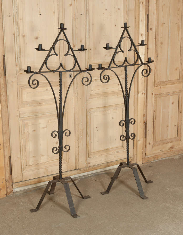 Hand-forged from red-hot iron, perfect for indoor or outdoor use, this pair of torcheres feature a trefoil motif representing the Holy Trinity! 
Circa 1850s. 
Each measures 63H x 26W x 24D.