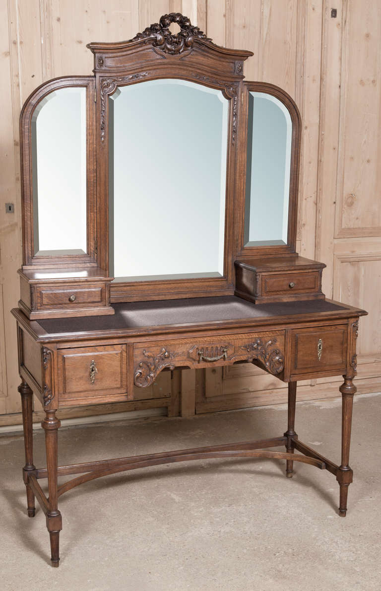 Exceptional hand-carved detail and original beveled mirrors! 
Circa 1870s. 
Measures 72.5H x 47.5W x 19.5D; surface 32H.