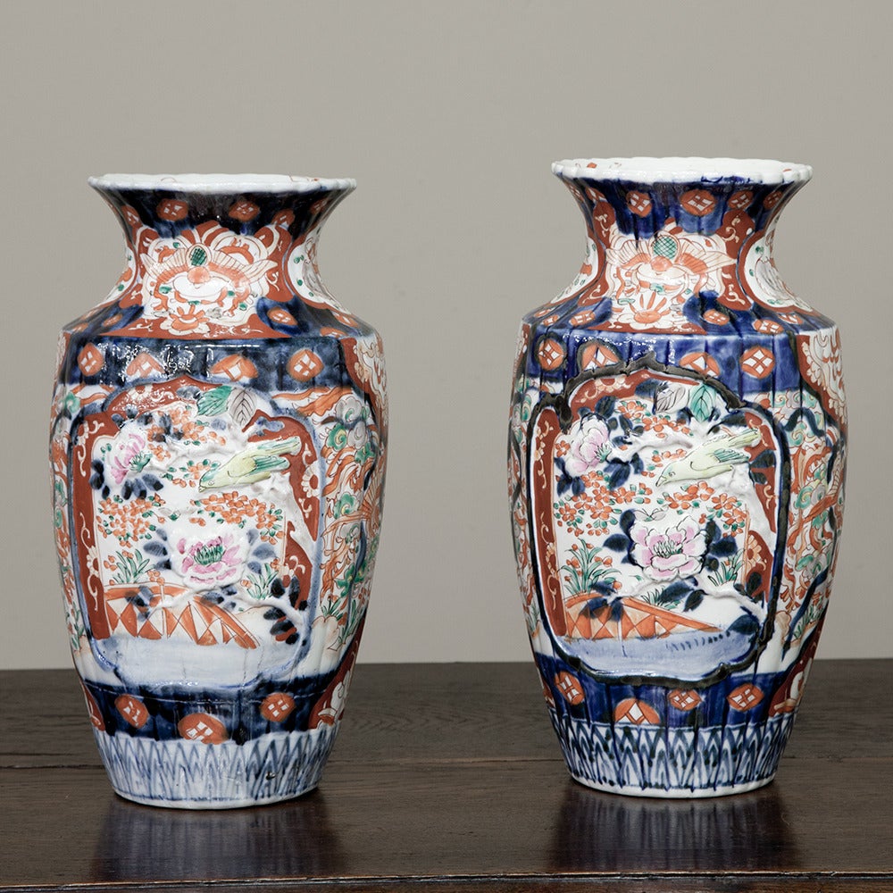 This colorful PAIR of 19th Century Imari Vases are perfect for collectors and those who wish to add a dash of color and Oriental style to a decor.  Hand-thrown into classic shapes, the entire outside and even inside the lip above have been