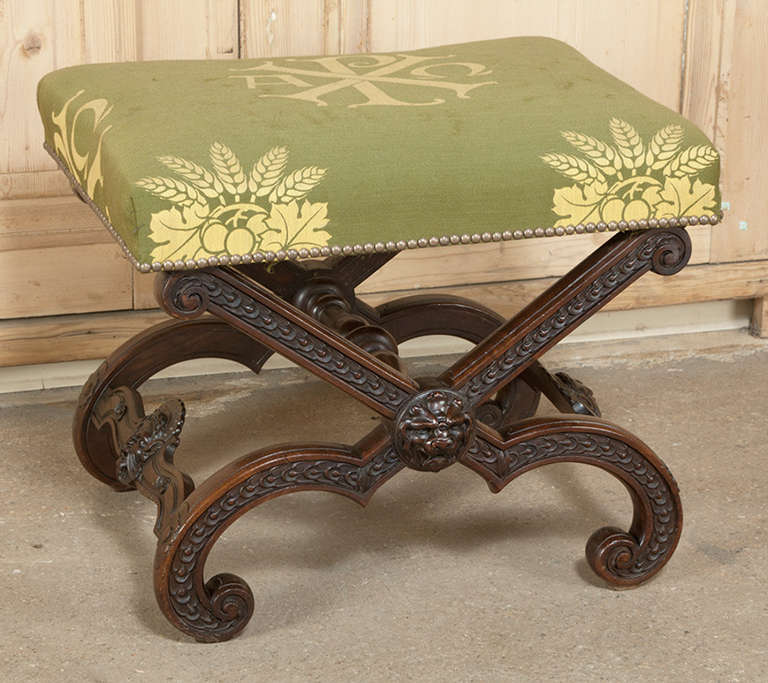 Ideal for the vanity or powder room, this Antique French Vanity Stool emulates the design that dates back to ancient Greece and Egypt.  This variation, however, features straight and scrolled legs and stretchers, all completely carved with