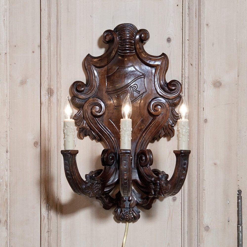 Carved with the initials T.R., this set of four Italian Baroque Wall Sconces are the perfect choice for symmetrical illumination.  The majesty of the Baroque style was designed to literally impress kings and queens, with a stylistic interpretation