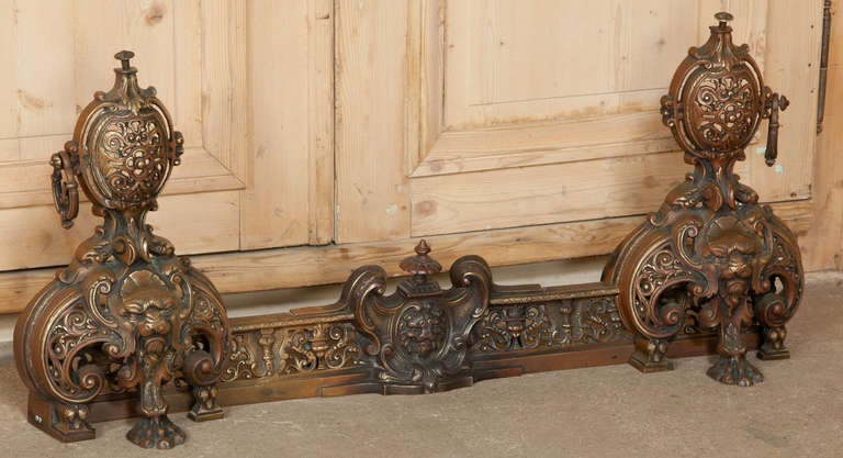 This Antique Italian Renaissance Bronze Fender/Andirons set is an exceptional example of the mastery of metalworking, inspired by the Renaissance, and featuring a fender upon which the andirons can be adjusted left and right to perfectly fit your