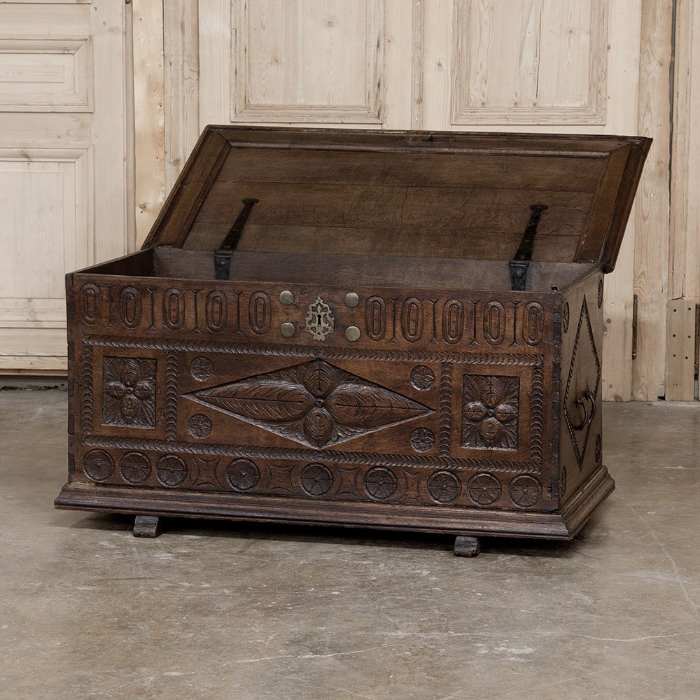The hand-carved detail on this 18th century Renaissance trunk is remarkable, and the makers chose to fit it with internal forged iron hinges and brass keyguards and lock mountings for added appeal. Perfect in a hall, at the foot of the bed, or as a
