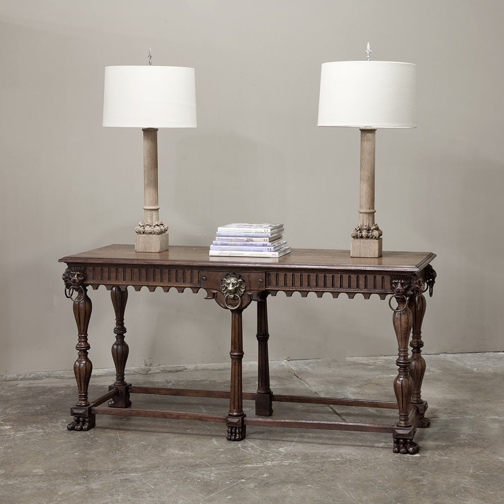 This stunning 19th century Renaissance sofa table features Four Lions hand-carved into the tops of the corner posts, with a pair of bronze lions at the center on the long sides! Beautifully turned, fluted legs and lions' paw feet add a nice touch,