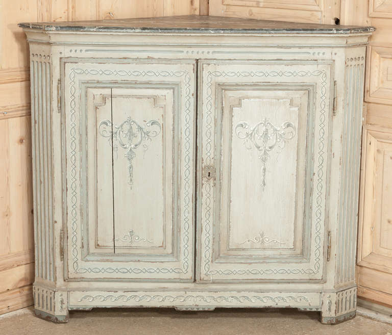 18th century Louis XVI French Painted Corner Buffet is perfect for making a focal point from a corner, productive storage and a nice surface. All with a elegant and casual French look that is perfect for a relaxed decor.  Striking neoclassical