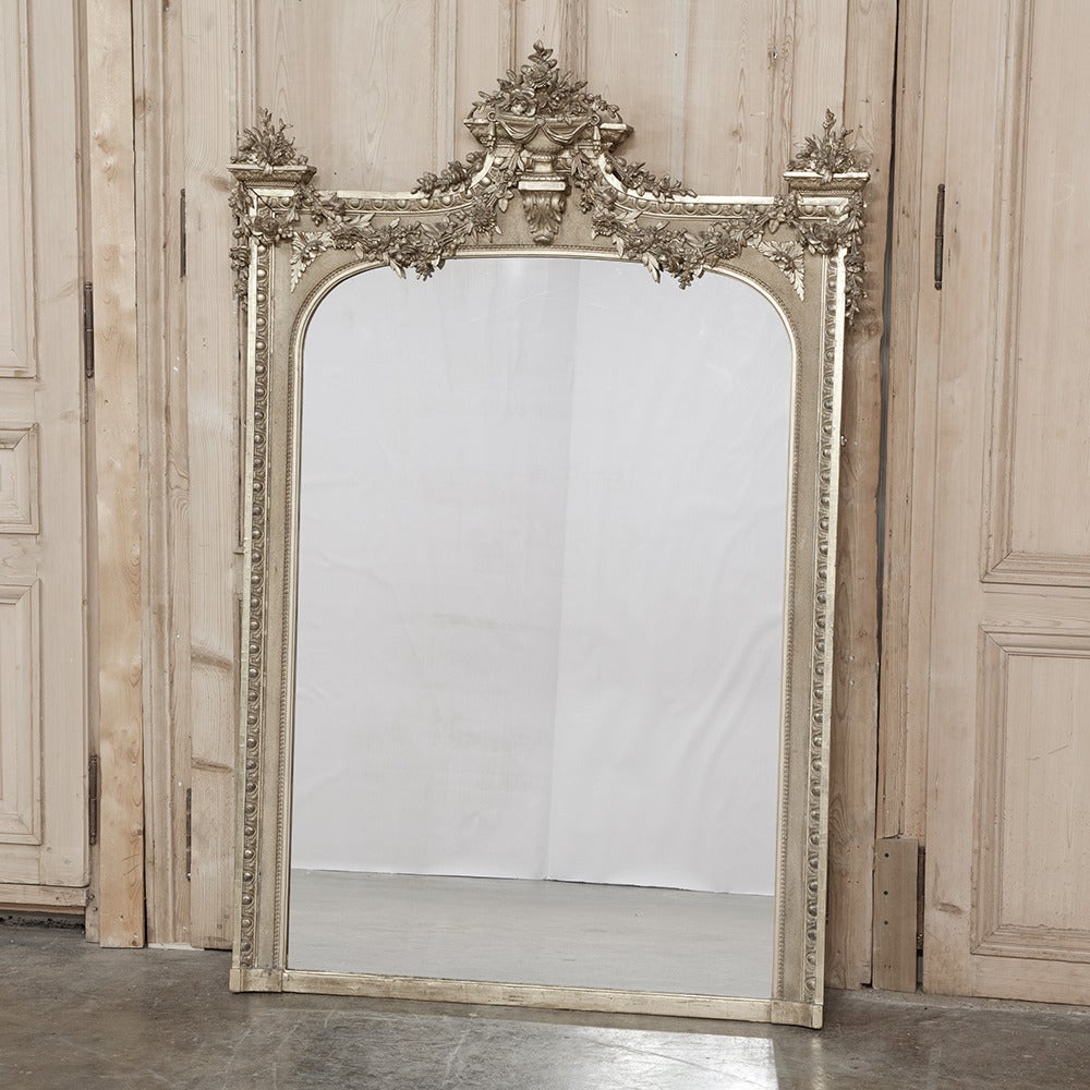 The splendor of the Neoclassical Revival in the latter part of the 19th century resulted in amazing works such as this gorgeous gilded mirror. With floral bouquets, garlands and sprays at the top, it features Fine molded detail all the way down to