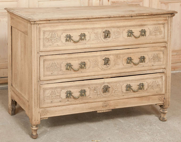 This boldly carved Antique Country French Commode was hand-crafted during the Louis XVI period and remains in remarkable condition for its age!  The carved embellishment was influenced heavily by the neoclassicism that was revived during the period,