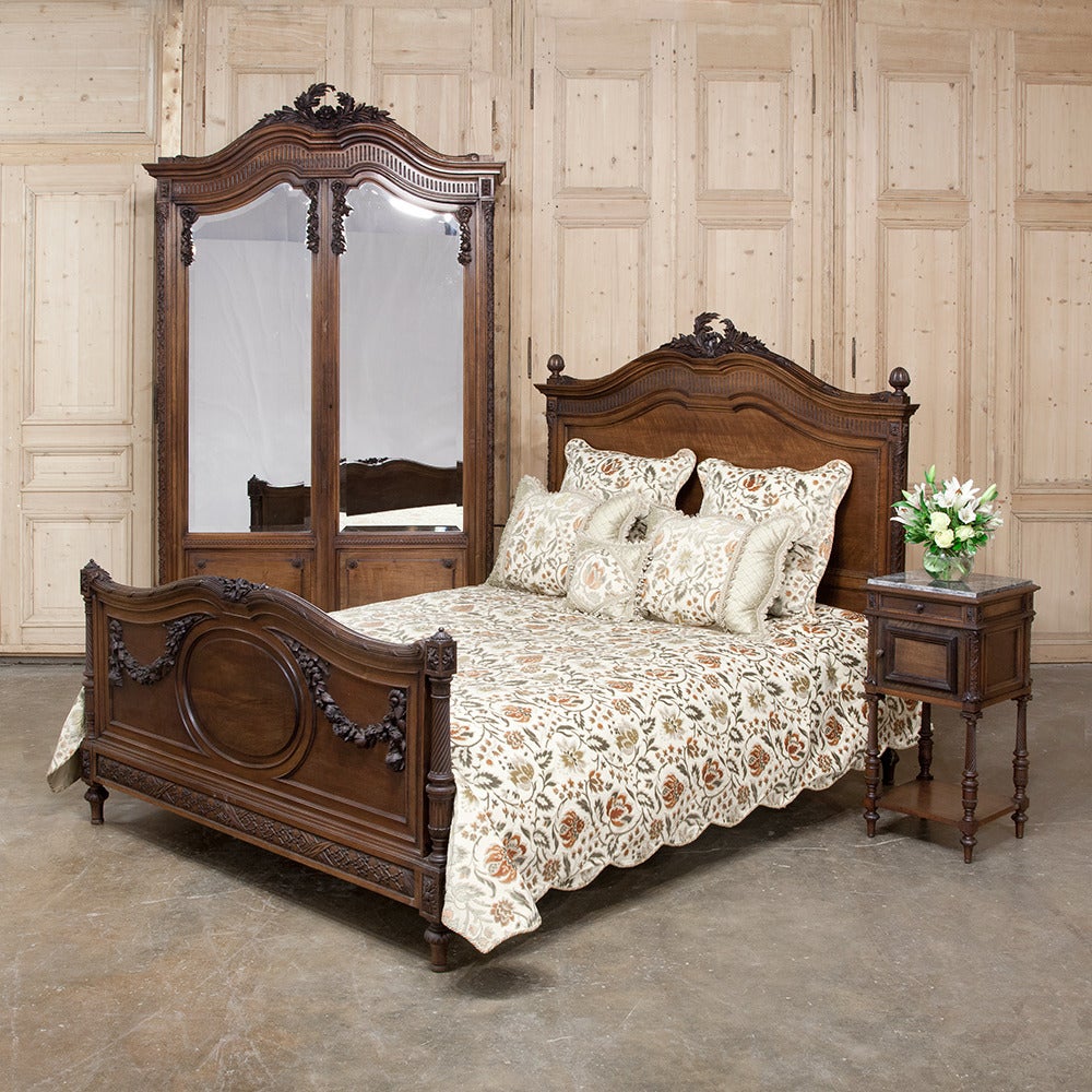 19th century neoclassical French walnut Queen bed represents the transition between the elements of the Rococo style merging with the neoclassical movement that overtook the continent in the second half of the 18th century and then was revived the