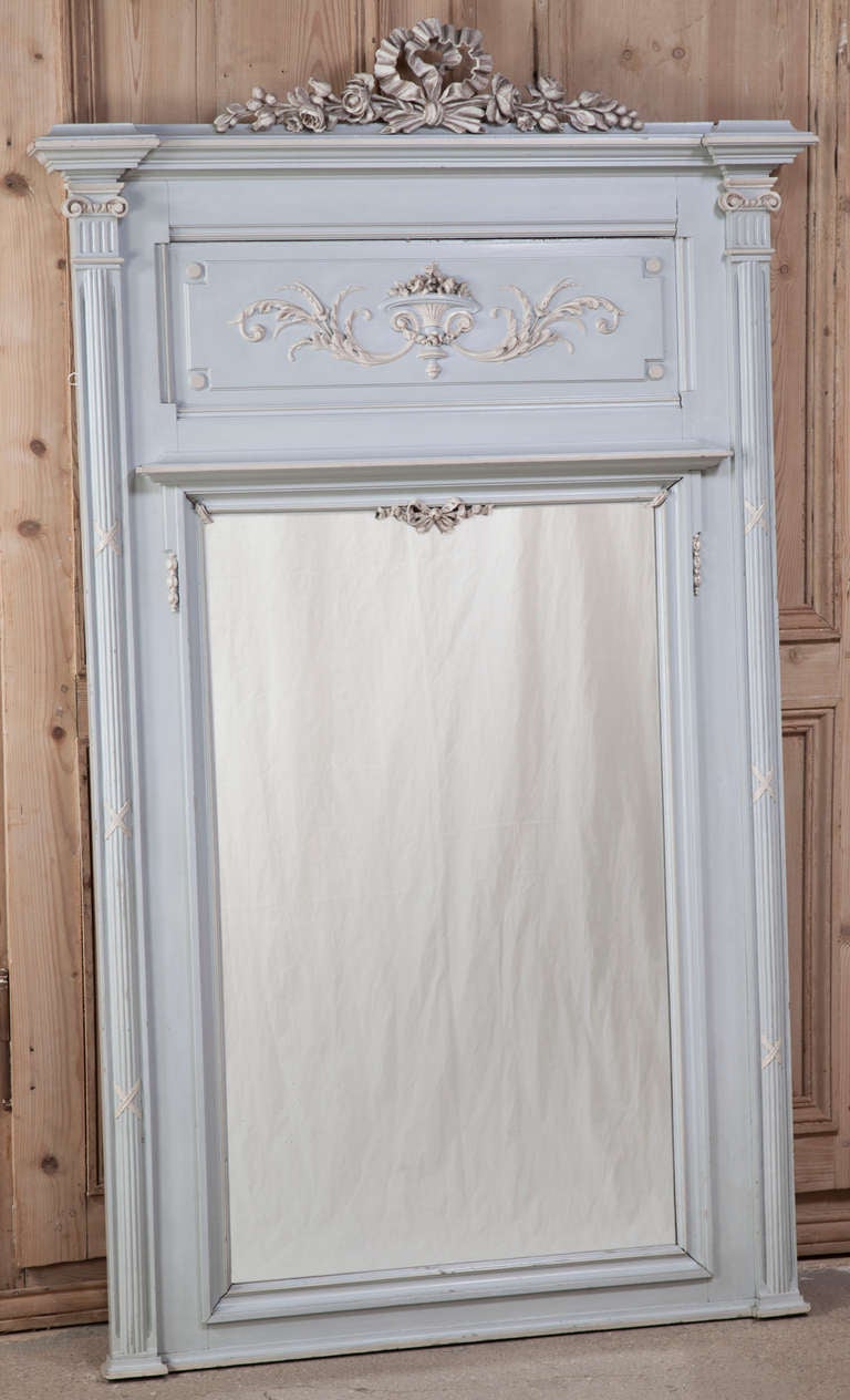 Hand-carved with timeless classical motifs in the manner of Louis XVI, this trumeau's painted finish has attained a lovely patina over the decades, and makes a perfect choice for the Paris Country or 