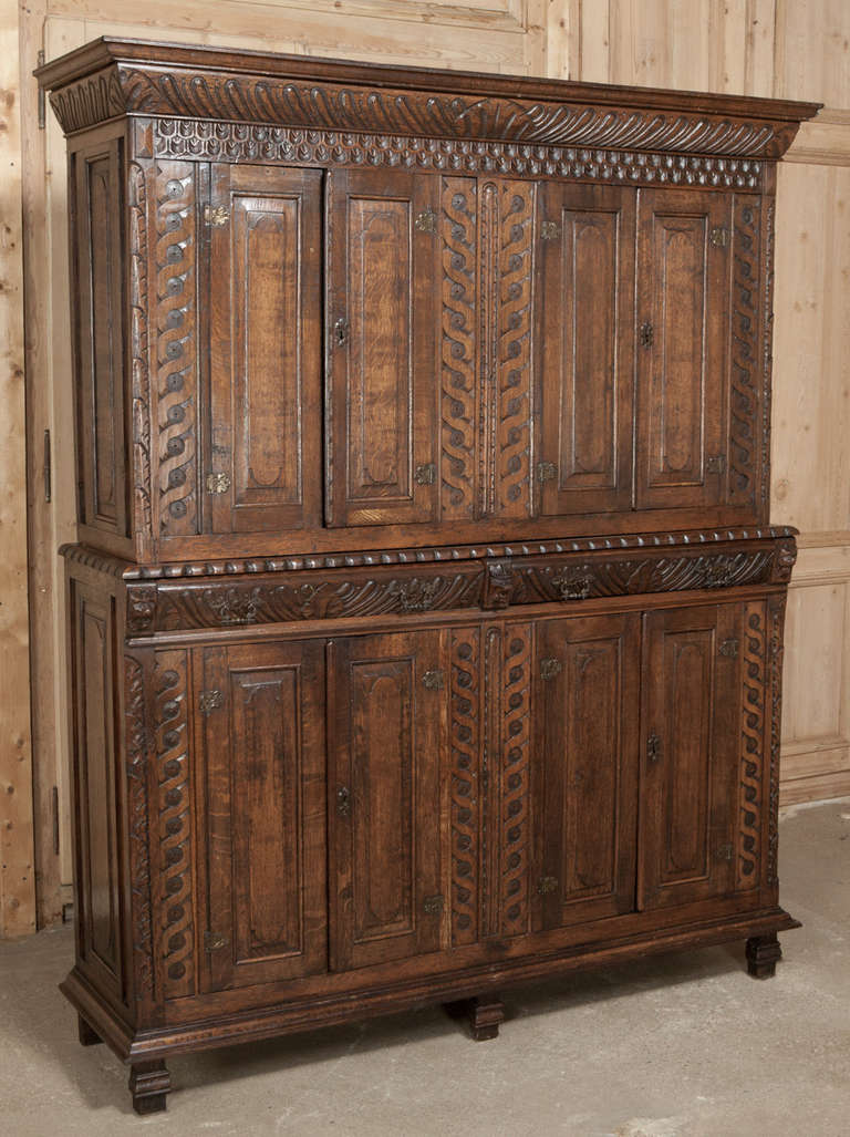 Rendered from solid oak, featuring eight doors and two drawers to create a superlative Old World cabinet. 
Circa 1900. 
Measures 84H x 66W x 19D.