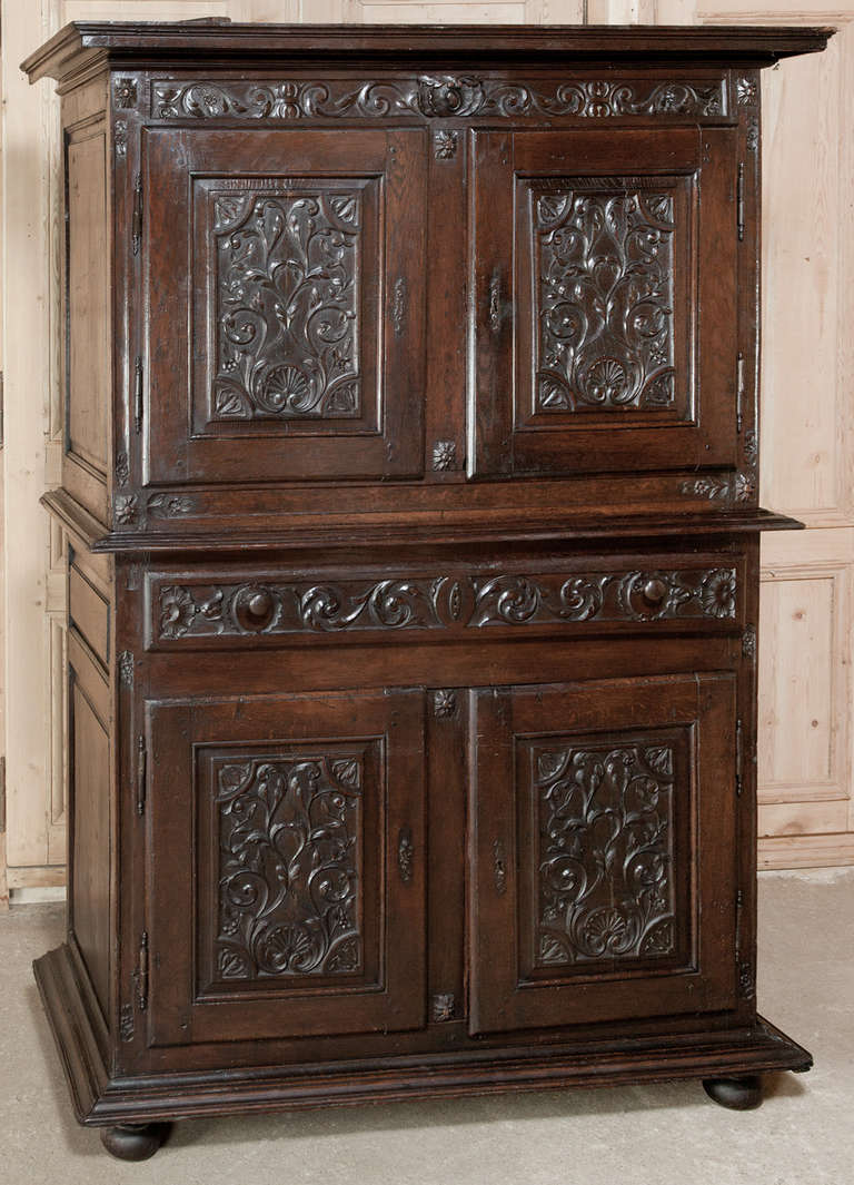 Featuring superlative hand-carved detail, this Antique 18th Century Italian Country Armoire boasts four doors and a full width drawer!  The carved embellishment is phenomenal, especially considering the use of what today would be considered