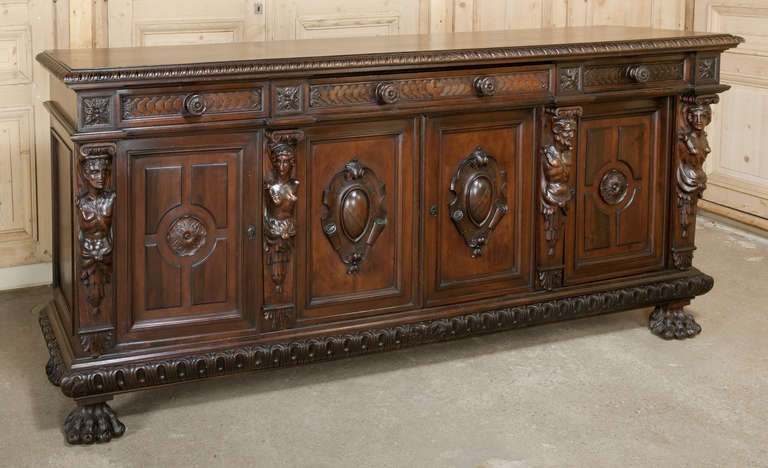 The splendor of the Renaissance executed in sumptuous Italian walnut expressed to the fullest in this antique Italian Renaissance buffet! 
Circa 1890s. 
Measures 41H x 90W x 23D